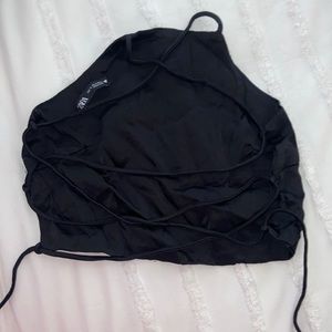 Black, silky, cropped halter—Zara brand. Backless with strappy tie in back.